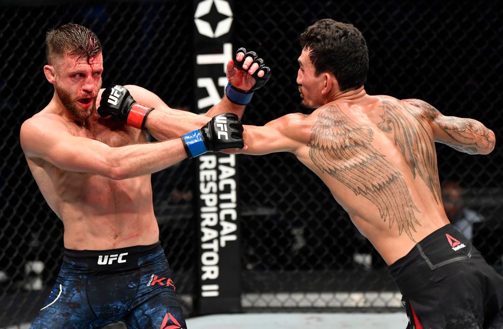 ABU DHABI, UNITED ARAB EMIRATES - JULY 12: In this handout image provided by UFC, (R-L) Max Holloway punches Alexander Volkanovski of Australia in their UFC featherweight championship fight during the UFC 251 event at Flash Forum on UFC Fight Island on July 12, 2020 on Yas Island, Abu Dhabi, United Arab Emirates. (Photo by Jeff Bottari/Zuffa LLC via Getty Images)