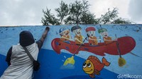 Kini gambar ikan hingga perahu dayung menghiasi dinding turap Sungai Ciliwung.
