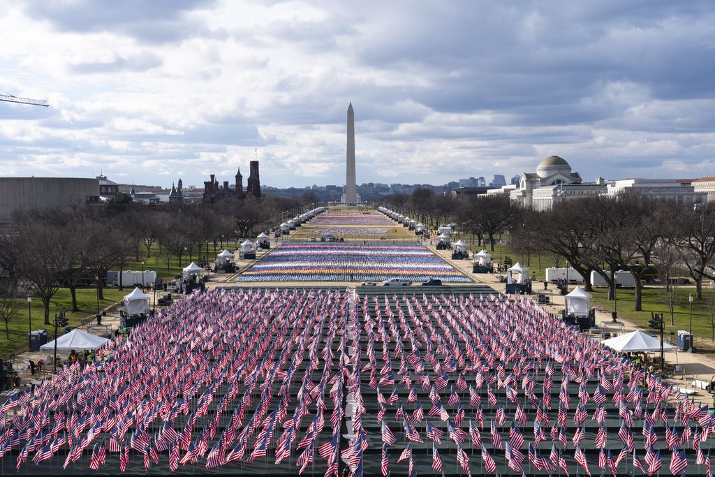 The U.S. Capitol is seen between flags placed on the National Mall ahead of the inauguration of President-elect Joe Biden and Vice President-elect Kamala Harris, Monday, Jan. 18, 2021, in Washington.