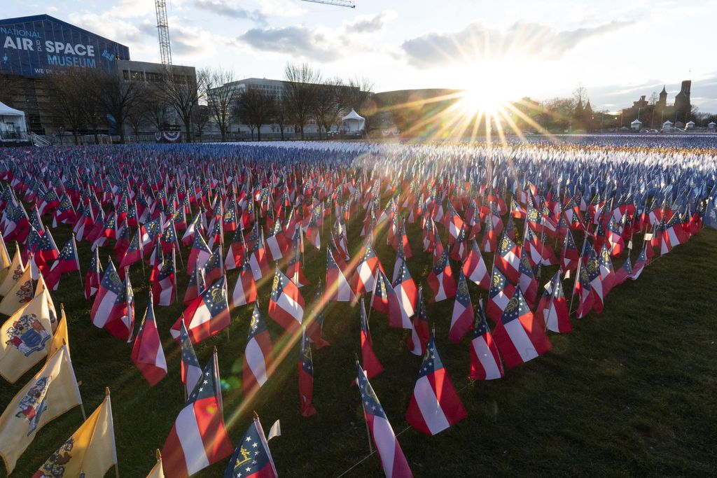 The U.S. Capitol is seen between flags placed on the National Mall ahead of the inauguration of President-elect Joe Biden and Vice President-elect Kamala Harris, Monday, Jan. 18, 2021, in Washington.