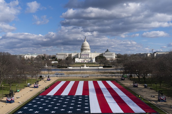 The U.S. Capitol is seen between flags placed on the National Mall ahead of the inauguration of President-elect Joe Biden and Vice President-elect Kamala Harris, Monday, Jan. 18, 2021, in Washington.