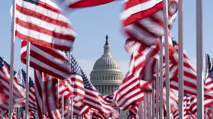 The U.S. Capitol is seen between flags placed on the National Mall ahead of the inauguration of President-elect Joe Biden and Vice President-elect Kamala Harris, Monday, Jan. 18, 2021, in Washington.