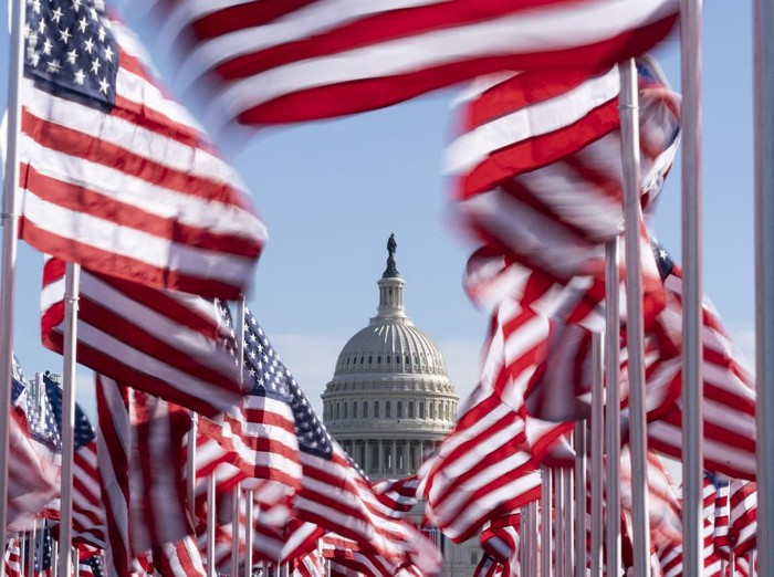 The U.S. Capitol is seen between flags placed on the National Mall ahead of the inauguration of President-elect Joe Biden and Vice President-elect Kamala Harris, Monday, Jan. 18, 2021, in Washington.