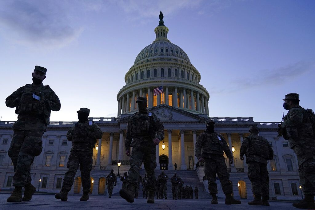 The U.S. Capitol is seen between flags placed on the National Mall ahead of the inauguration of President-elect Joe Biden and Vice President-elect Kamala Harris, Monday, Jan. 18, 2021, in Washington.