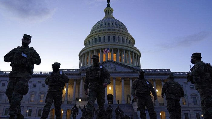 The U.S. Capitol is seen between flags placed on the National Mall ahead of the inauguration of President-elect Joe Biden and Vice President-elect Kamala Harris, Monday, Jan. 18, 2021, in Washington.
