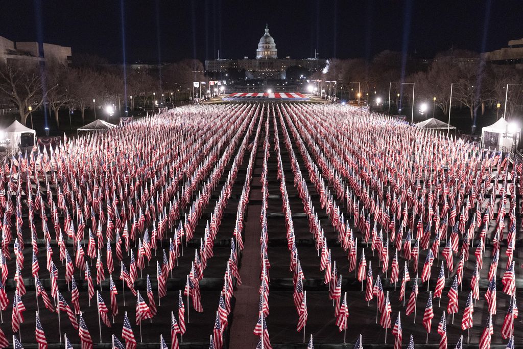 The U.S. Capitol is seen between flags placed on the National Mall ahead of the inauguration of President-elect Joe Biden and Vice President-elect Kamala Harris, Monday, Jan. 18, 2021, in Washington.