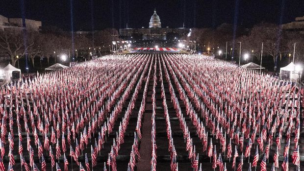 The U.S. Capitol is seen between flags placed on the National Mall ahead of the inauguration of President-elect Joe Biden and Vice President-elect Kamala Harris, Monday, Jan. 18, 2021, in Washington.