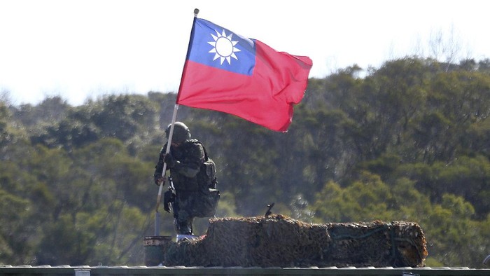 Soldiers fire during a military exercise in Hsinchu County, northern Taiwan, Tuesday, Jan. 19, 2021. Taiwanese troops using tanks, mortars and small arms staged a drill Tuesday aimed at repelling an attack from China, which has increased its threats to reclaim the island and its own displays of military might. (AP Photo/Chiang Ying-ying)