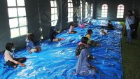 Sejumlah anak pengungsi korban gempa bumi mengikuti kegiatan trauma healing di lokasi pengungsian Stadion Manakarra Mamuju, Sulawesi Barat, Selasa (19/1/2021).  