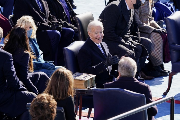 President Joe Biden, center, smiles after speaking at the 59th Presidential Inauguration at the U.S. Capitol in Washington, Wednesday, Jan. 20, 2021. (Kevin Dietsch/Pool Photo via AP)