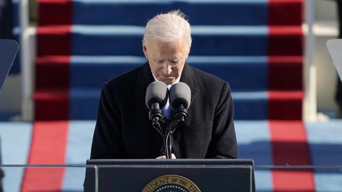 President Joe Biden, center, smiles after speaking at the 59th Presidential Inauguration at the U.S. Capitol in Washington, Wednesday, Jan. 20, 2021. (Kevin Dietsch/Pool Photo via AP)
