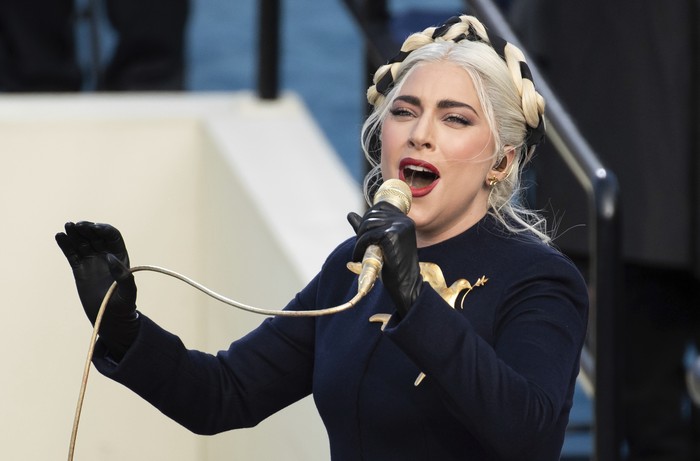 Lady Gaga performs the National Anthem as President-elect Joe Biden applauds during the 59th Presidential Inauguration at the U.S. Capitol in Washington, Wednesday, Jan. 20, 2021. (AP Photo/Andrew Harnik)