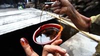 Pekerja mengecek bahan baku untuk membuatan etanol.