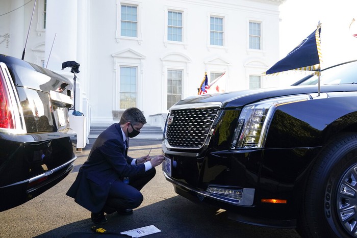 A U.S. Secret Service agent changes the license plate on President Joe Biden's limousine near the North Portico of the White House, Wednesday, Jan. 20, 2021, in Washington. (AP Photo/Alex Brandon, Pool)