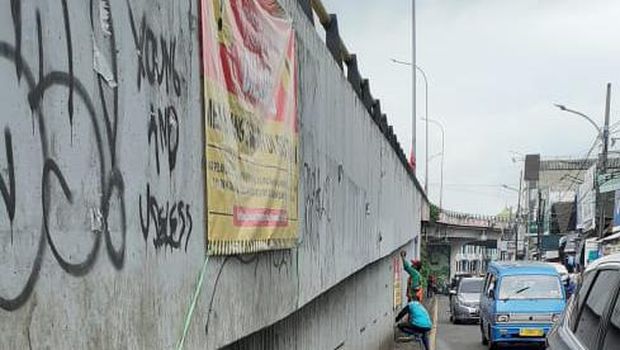 Spanduk dilarang membuang sampah dipasang di flyover Ciputat, Tangerang Selatan, Kamis (21/1).