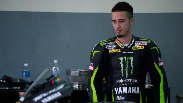 KUALA LUMPUR, MALAYSIA - JANUARY 31: Andrea Dovizioso of Italy and Yamaha Tech 3 looks on the bike in box during the first day of MotoGP testing at Sepang Circuit on January 31, 2012 in Kuala Lumpur, Malaysia. (Photo by Mirco Lazzari gp/Getty Images)