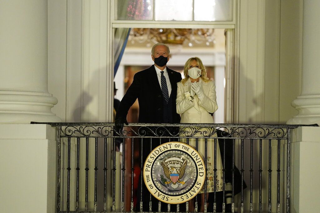 President Joe Biden and first lady Jill Biden watch fireworks from the White House, Wednesday, Jan. 20, 2021, in Washington. (AP Photo/Evan Vucci)