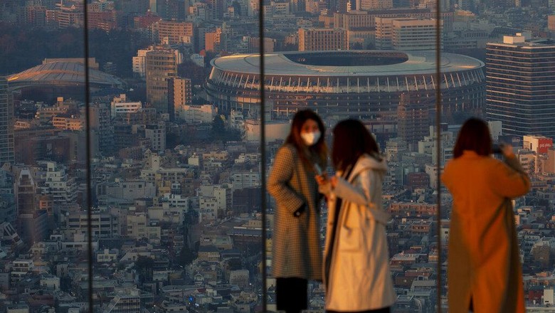 Japan National Stadium, where opening ceremony and many other events are planned for postponed Tokyo 2020 Olympics, is seen from a rooftop observation deck Thursday, Jan. 21, 2021, in Tokyo. IOC President Thomas Bach and local organizers are pushing back against reports that the postponed Tokyo Olympics will be canceled and will not open in six months on July 23. The Tokyo Games were postponed 10 months ago at the outbreak of the coronavirus pandemic, and now their future appears threatened again.
