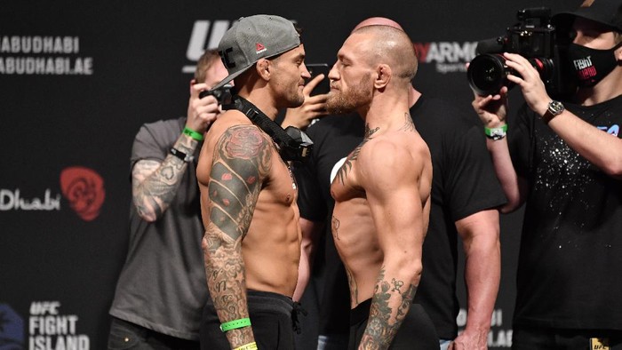 ABU DHABI, UNITED ARAB EMIRATES - JANUARY 22:  In this handout image provided by the UFC, (L-R) Opponents Dustin Poirier and Conor McGregor of Ireland face off during the UFC 257 weigh-in at Etihad Arena on UFC Fight Island on January 22, 2021 in Abu Dhabi, United Arab Emirates. (Photo by Jeff Bottari/Zuffa LLC via Getty Images)