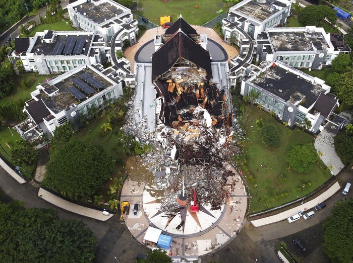 A government building is seen badly damaged following an earthquake in this aerial photo taken using a drone in Mamuju, West Sulawesi, Indonesia, Saturday, Jan. 16, 2021. Damaged roads and bridges, power blackouts and lack of heavy equipment on Saturday hampered Indonesias rescuers after a strong and shallow earthquake left a number of people dead and injured on Sulawesi island. (AP Photo/Abdi Latief)