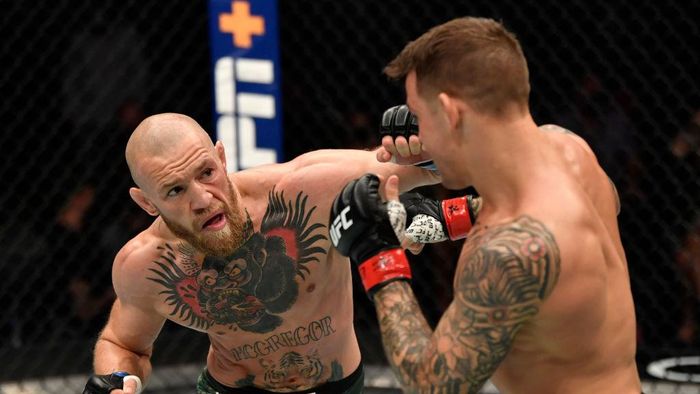 Conor McGregor ABU DHABI, UNITED ARAB EMIRATES - JANUARY 23: In this handout image provided by the UFC, (L-R) Conor McGregor of Ireland punches Dustin Poirier in a lightweight fight during the UFC 257 event inside Etihad Arena on UFC Fight Island on January 23, 2021 in Abu Dhabi, United Arab Emirates. (Photo by Jeff Bottari/Zuffa LLC via Getty Images)