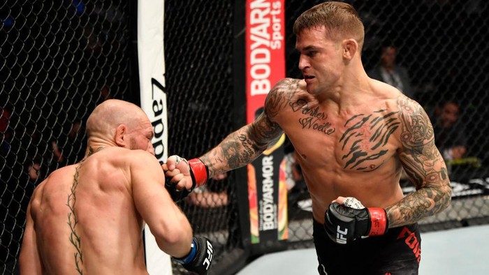 ABU DHABI, UNITED ARAB EMIRATES - JANUARY 23: In this handout image provided by the UFC, (R-L) Dustin Poirier punches Conor McGregor of Ireland in a lightweight fight during the UFC 257 event inside Etihad Arena on UFC Fight Island on January 23, 2021 in Abu Dhabi, United Arab Emirates. (Photo by Jeff Bottari/Zuffa LLC via Getty Images)