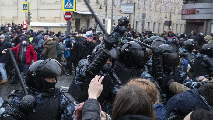 Police officers detain a man dressed in a horned, fur hat, and holding Russian flag during a protest against the jailing of opposition leader Alexei Navalny in Moscow, Russia, Saturday, Jan. 23, 2021. Russian police on Saturday arrested hundreds of protesters who took to the streets in temperatures as low as minus-50 C (minus-58 F) to demand the release of Alexei Navalny, the countrys top opposition figure. (AP Photo/Pavel Golovkin)
