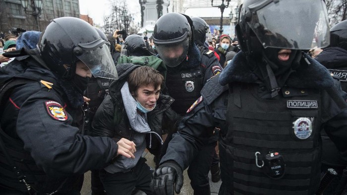 Police officers detain a man dressed in a horned, fur hat, and holding Russian flag during a protest against the jailing of opposition leader Alexei Navalny in Moscow, Russia, Saturday, Jan. 23, 2021. Russian police on Saturday arrested hundreds of protesters who took to the streets in temperatures as low as minus-50 C (minus-58 F) to demand the release of Alexei Navalny, the countrys top opposition figure. (AP Photo/Pavel Golovkin)