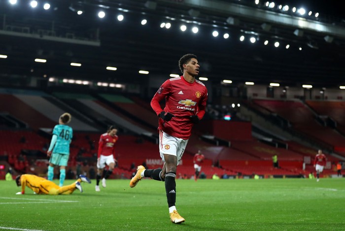 MANCHESTER, ENGLAND - JANUARY 24: Marcus Rashford of Manchester United celebrates after scoring their sides second goal during The Emirates FA Cup Fourth Round match between Manchester United and Liverpool at Old Trafford on January 24, 2021 in Manchester, England. Sporting stadiums around the UK remain under strict restrictions due to the Coronavirus Pandemic as Government social distancing laws prohibit fans inside venues resulting in games being played behind closed doors. (Photo by Martin Rickett - Pool/Getty Images)