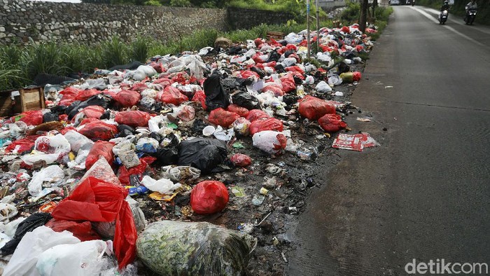 Sampah menumpuk di pinggir Tol JORR Jati Warna, Kota Bekasi, Jumat (29/01/2021). Sampah ini menimbulkan bau busuk yang menyengat.
