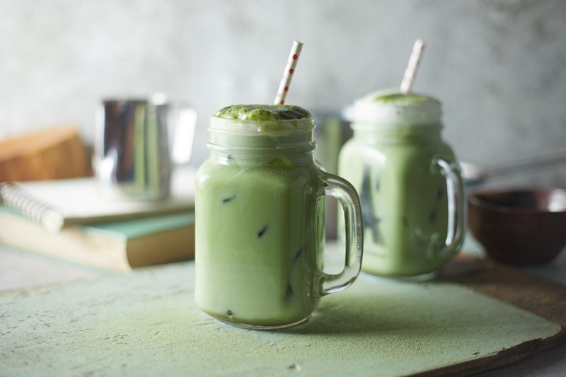 Homemade iced matcha latte tea with milk.