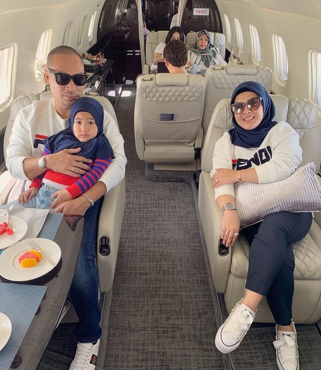Adik Syahrini, Aisyahrani, juga menggunakan jet pribadi. Ia kompak bersama suaminya menggunakan sweater dari rumah mode Fendi. (Foto: Instagram)