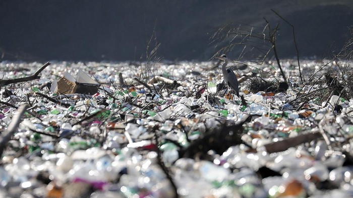 Plastic bottles and waste float at the Potpecko accumulation lake near Priboj, in southwest Serbia, Friday, Jan. 22, 2021. Serbia and other Balkan nations are virtually drowning in communal waste after decades of neglect and lack of efficient waste-management policies in the countries aspiring to join the European Union.