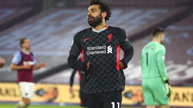 Liverpool's Mohamed Salah celebrates after scoring his side's second goal during the English Premier League match between West Ham and Liverpool at the the London Stadium in London, Sunday, Jan. 31, 2021. (Clive Rose/Pool via AP)