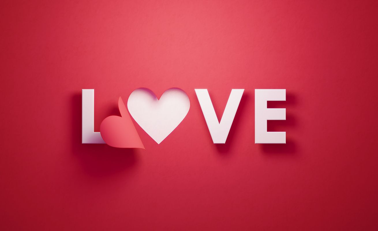 i love you lettering with hearts on 3 white paper pinned with 2 small red heart pegs and one big red heart pegs on cork board