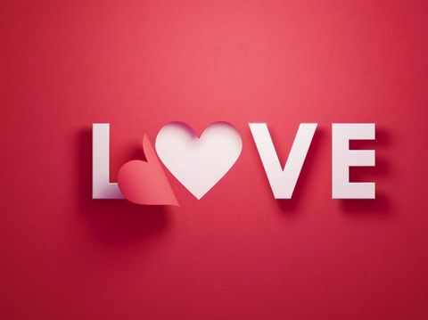 Ucapan Valentine's Day i love you lettering with hearts on 3 white paper pinned with 2 small red heart pegs and one big red heart pegs on cork board