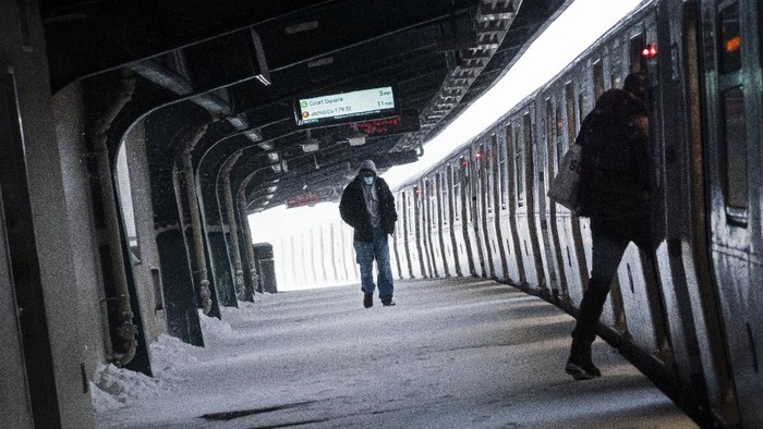 A man walks along a snow covered platform of a train station during a snowstorm, Monday, Feb. 1, 2021, in Brooklyn, New York. (AP Photo/Wong Maye-E)