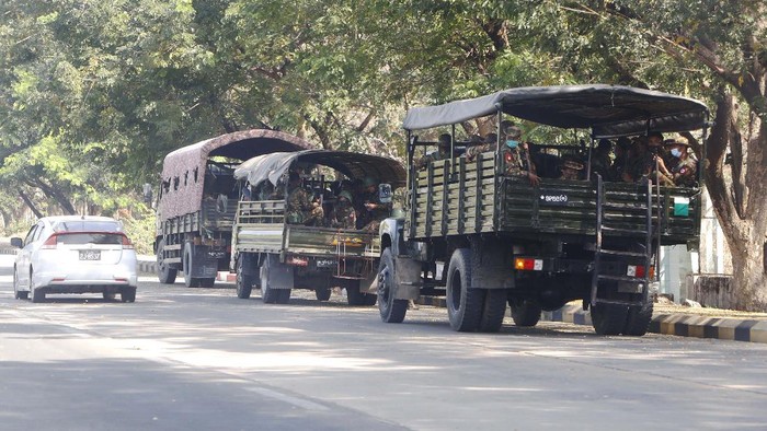 Soldiers sit inside trucks parked on a road in Naypyitaw, Myanmar, Monday, Feb. 1, 2021. Myanmar military television said Monday that the military was taking control of the country for one year, while reports said many of the countrys senior politicians including Aung San Suu Kyi had been detained. (AP Photo)