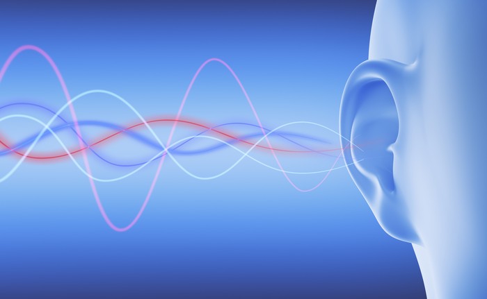Blue wireframe ear with noisy distorted sound waves - 3D illustration