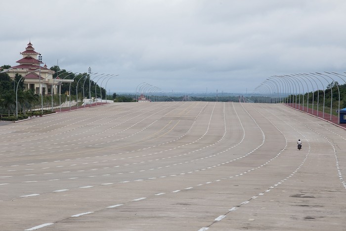 NAYPYITAW, BURMA - AUGUST 13:  A motorcyclist drives down a 20-lane highway on August 13, 2015 in Naypyitaw, Burma. The capital of Myanmar was moved from Yangon to Naypyitaw nearly 10 years ago, where, despite millions of dollars of government investment, the city has struggled to attract relocating Burmese locals or a substantial number of tourists.  (Photo by Taylor Weidman/Getty Images)