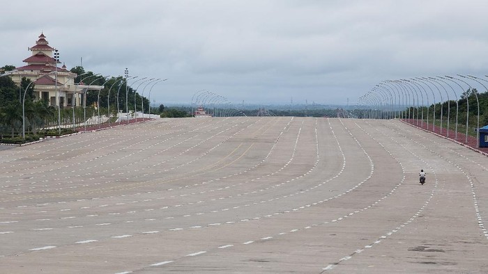 NAYPYITAW, BURMA - AUGUST 13:  A motorcyclist drives down a 20-lane highway on August 13, 2015 in Naypyitaw, Burma. The capital of Myanmar was moved from Yangon to Naypyitaw nearly 10 years ago, where, despite millions of dollars of government investment, the city has struggled to attract relocating Burmese locals or a substantial number of tourists.  (Photo by Taylor Weidman/Getty Images)