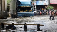Meski berbahaya, anak-anak ini tetap bermain di genangan tersebut.