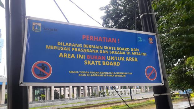 Spanduk larangan bermain skateboard di taman trotoar di kanal banjir barat (KBB), Seberang BNI City.