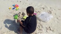 Bermain pasir di Gosong Patrick dan merasakan ombak kecil.