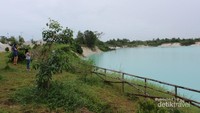 Beberapa orang wisatan menikmati keunikan Danau Kaolin