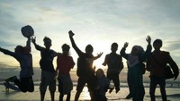Menikmati keindahan Pantai Kuta ketika matahari mulai terbenam dengan gaya lompatan yang unik dan fun