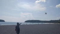 Menunjuk pulau di seberang Pantai Kata.