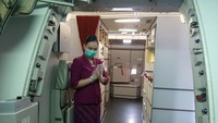 Pramugari menerapkan protokol kesehatan