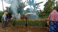 Ibu-ibu tengah memasak lemang
