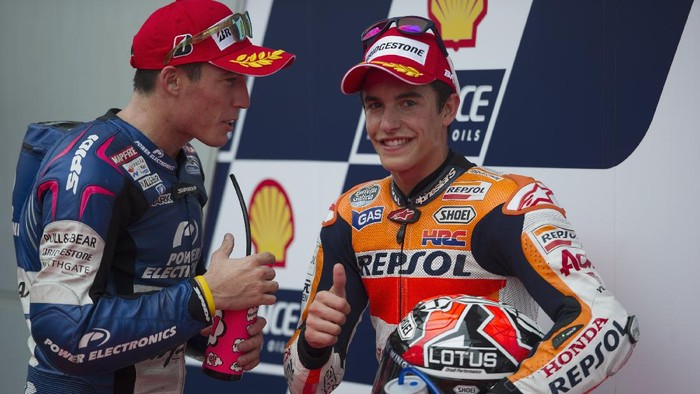KUALA LUMPUR, MALAYSIA - OCTOBER 12:  Marc Marquez of Spain and Repsol Honda Team celebrates the pole position with Aleix Espargaro (L) of Spain and Power Electronics Aspar (CRT Pole Position) at the end of the MotoGP Of Malaysia - Qualifying at Sepang Circuit on October 12, 2013 in Kuala Lumpur, Malaysia.  (Photo by Mirco Lazzari gp/Getty Images)
